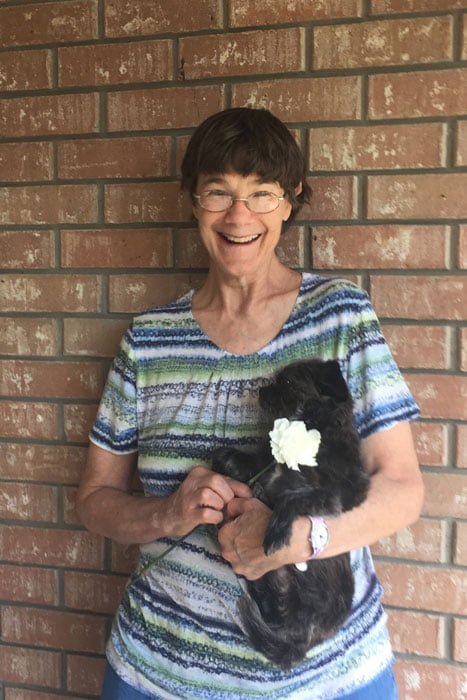 Photo of Ellis County Meals on Wheels client Ms. White and her dog