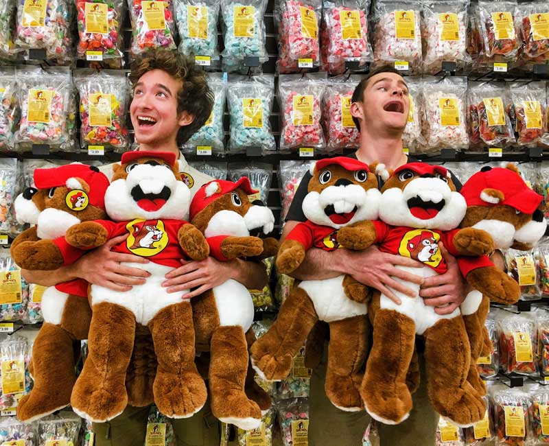Photo of two men holding Buc-ee's stuffed beavers