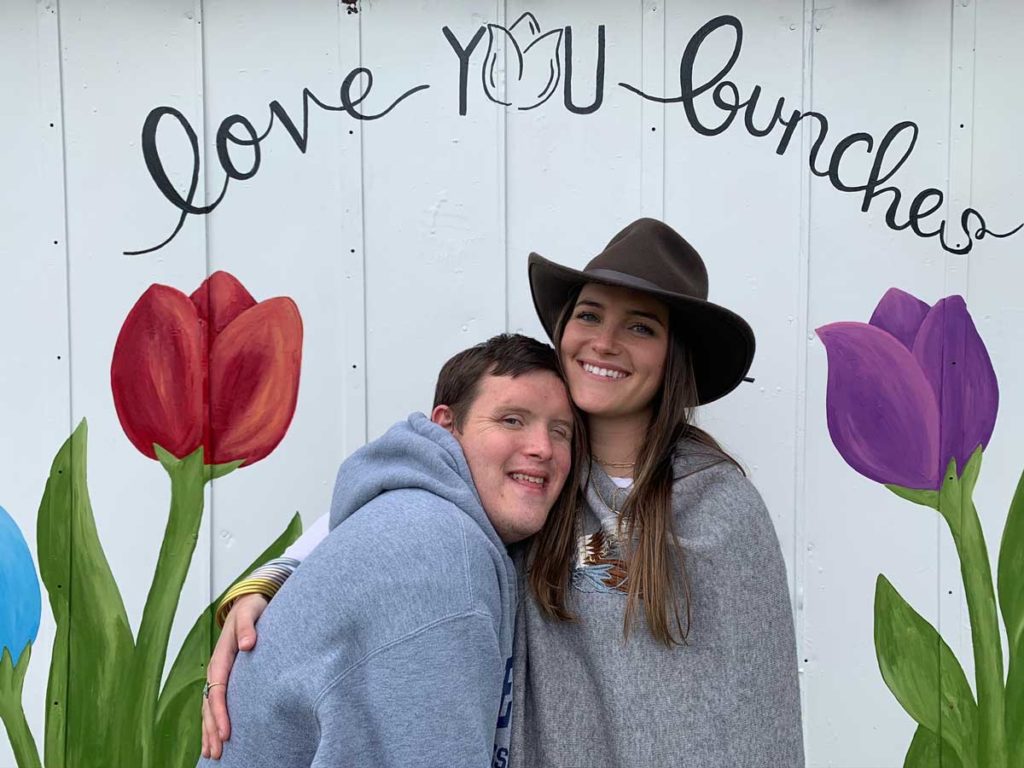 Photo of man and woman in front of sign at Poston Gardens Tulipalooza in Waxahachie Texas