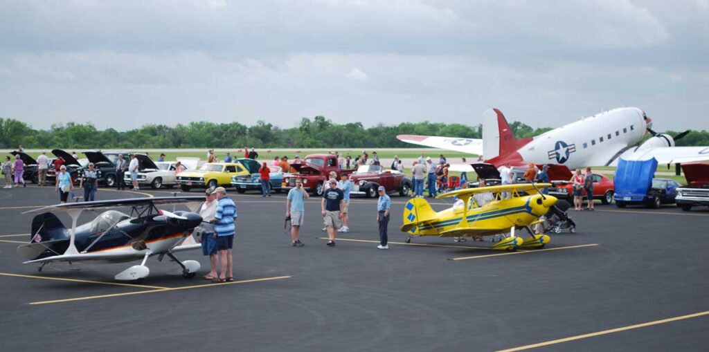 Photo of small planes and classic cars at Mid-Way Regional Airport in Midlothian, Texas