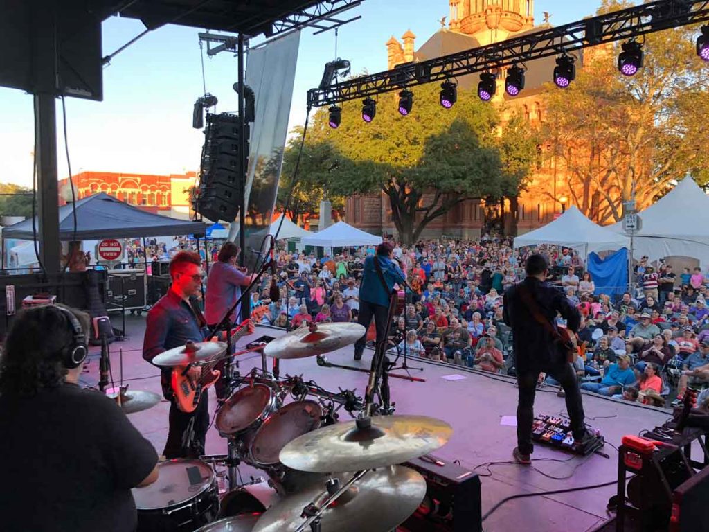 Musical performers on stage at Texas Country Reporter Festival in Waxahachie, Texas