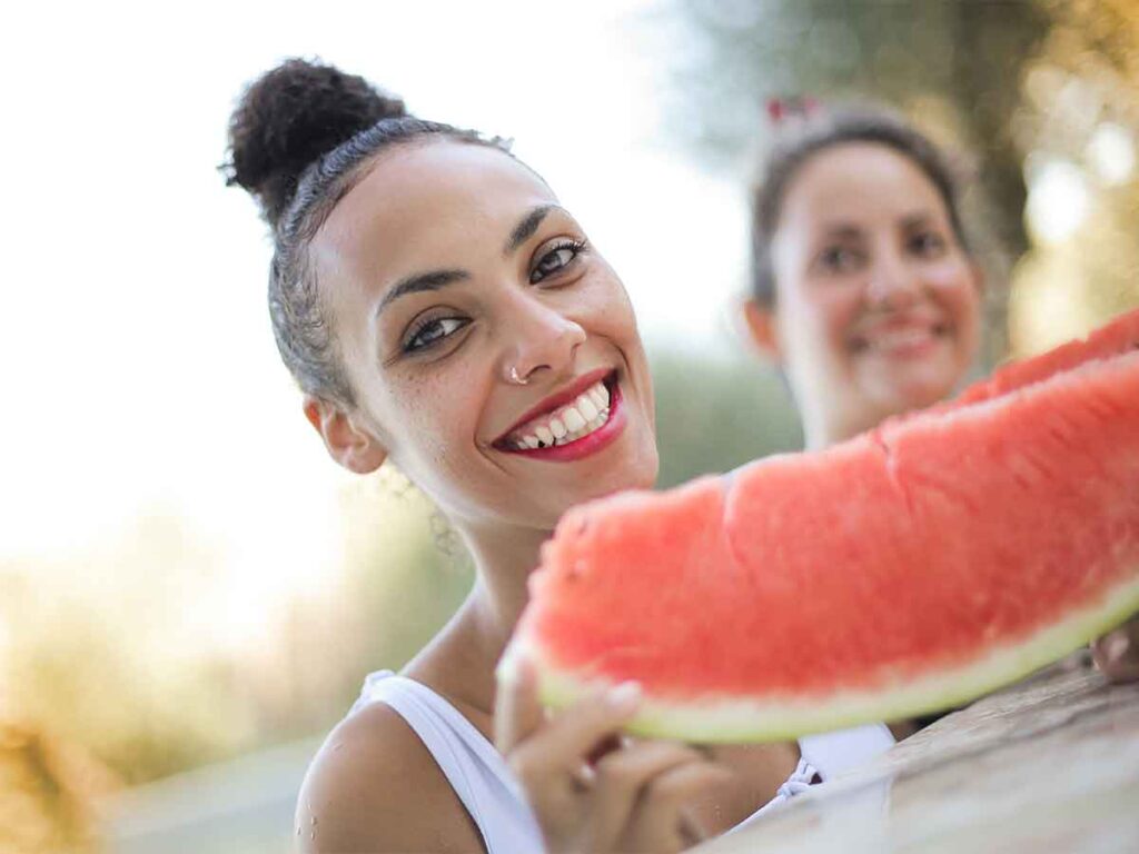 woman holding watermelon slice