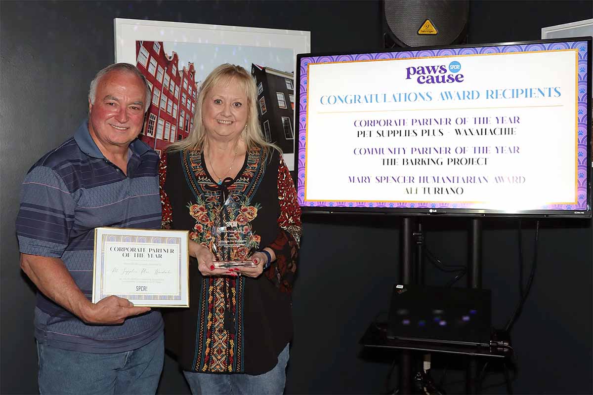 Rick and Barbara Garner pose with a certificate award from the S.P.C.A. of Texas.