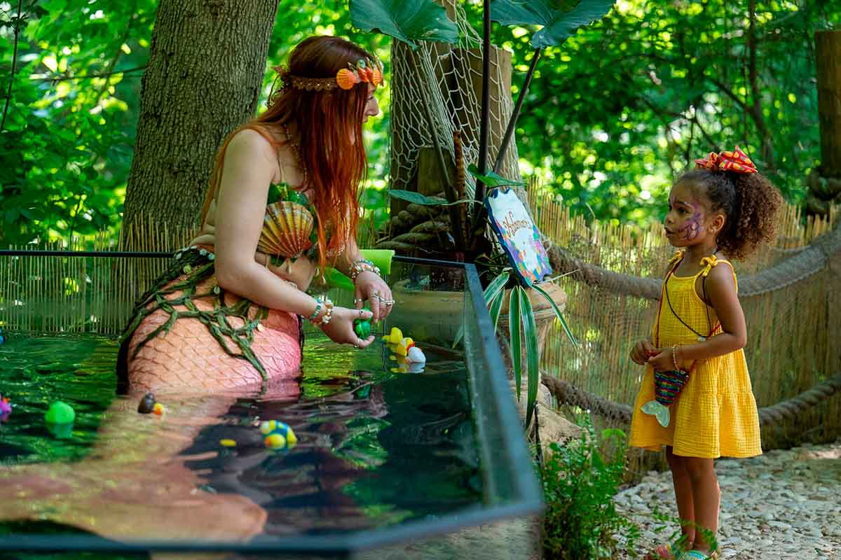 Woman dressed as a mermaid with a young girl at S.R.F. in Waxahachie, Texas