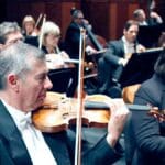 Musicians playing violin for the Fort Worth Symphony Orchestra